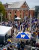 2021 Convocation at UW Tacoma - tents in foreground, crowds of attendees, Snoqualmie Power House in background.